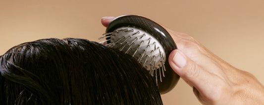 man uses Arey Scalp Brush to massage his scalp