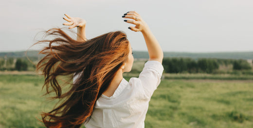 Woman with deep chestnut hair from boosted melanin production 