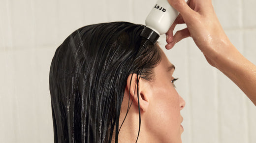 Woman using Arey exfoliating scalp scrub 